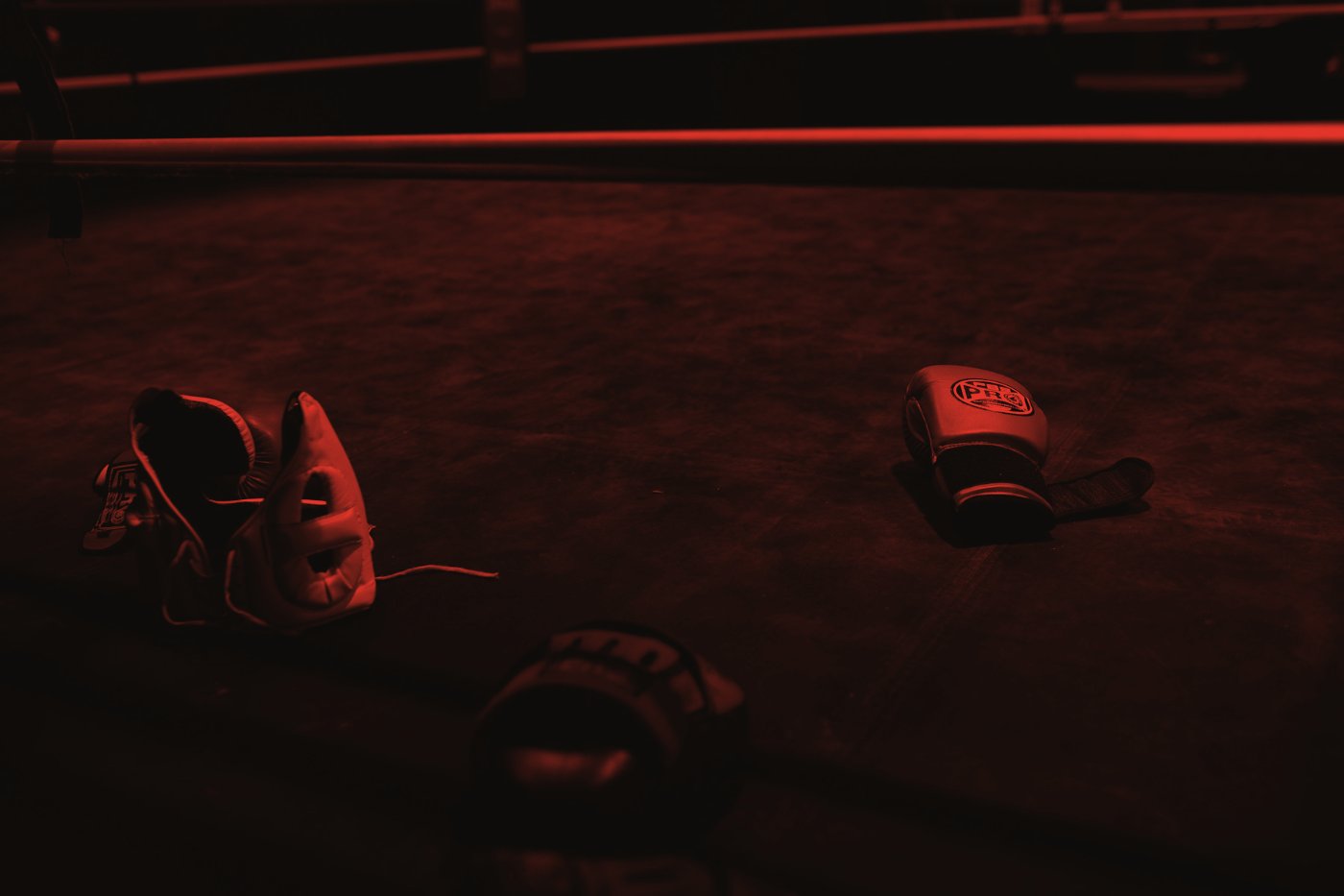 Gloves and headgear resting on the ring canvas